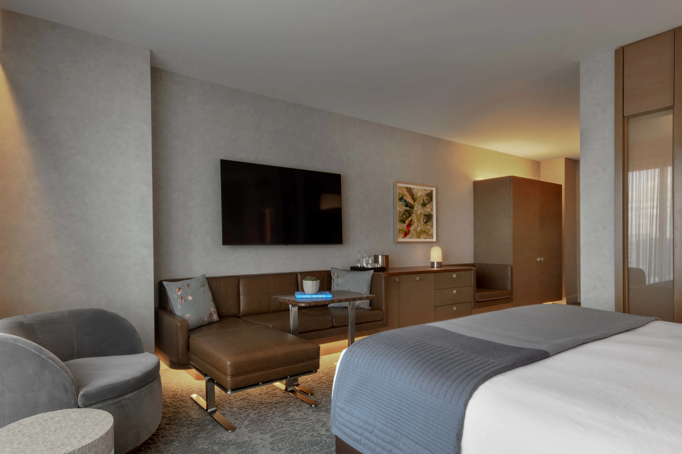 bedroom, leather couch, bed, television, chair