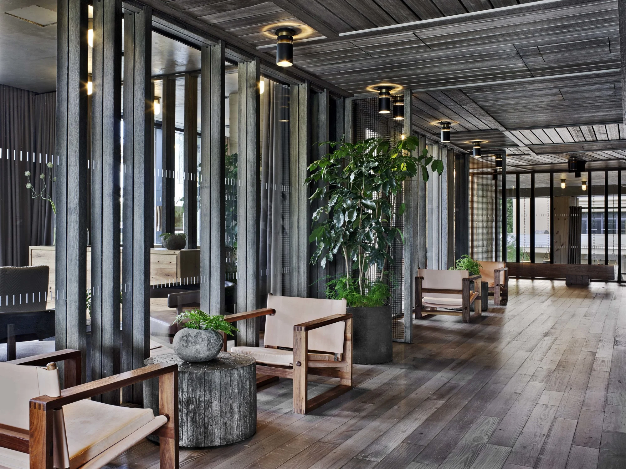 ChatGPT said: Armchairs  Planters  Wood  Ceiling lights  Partitions  Floorboards  Curtains  Side tables  Reflections  Greenery