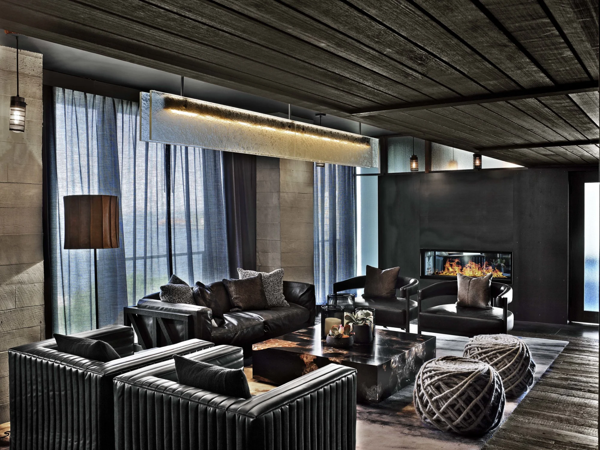 private room, fireplace, wood, leather,light, concrete, fabric, sofa, coffe table, carpet
