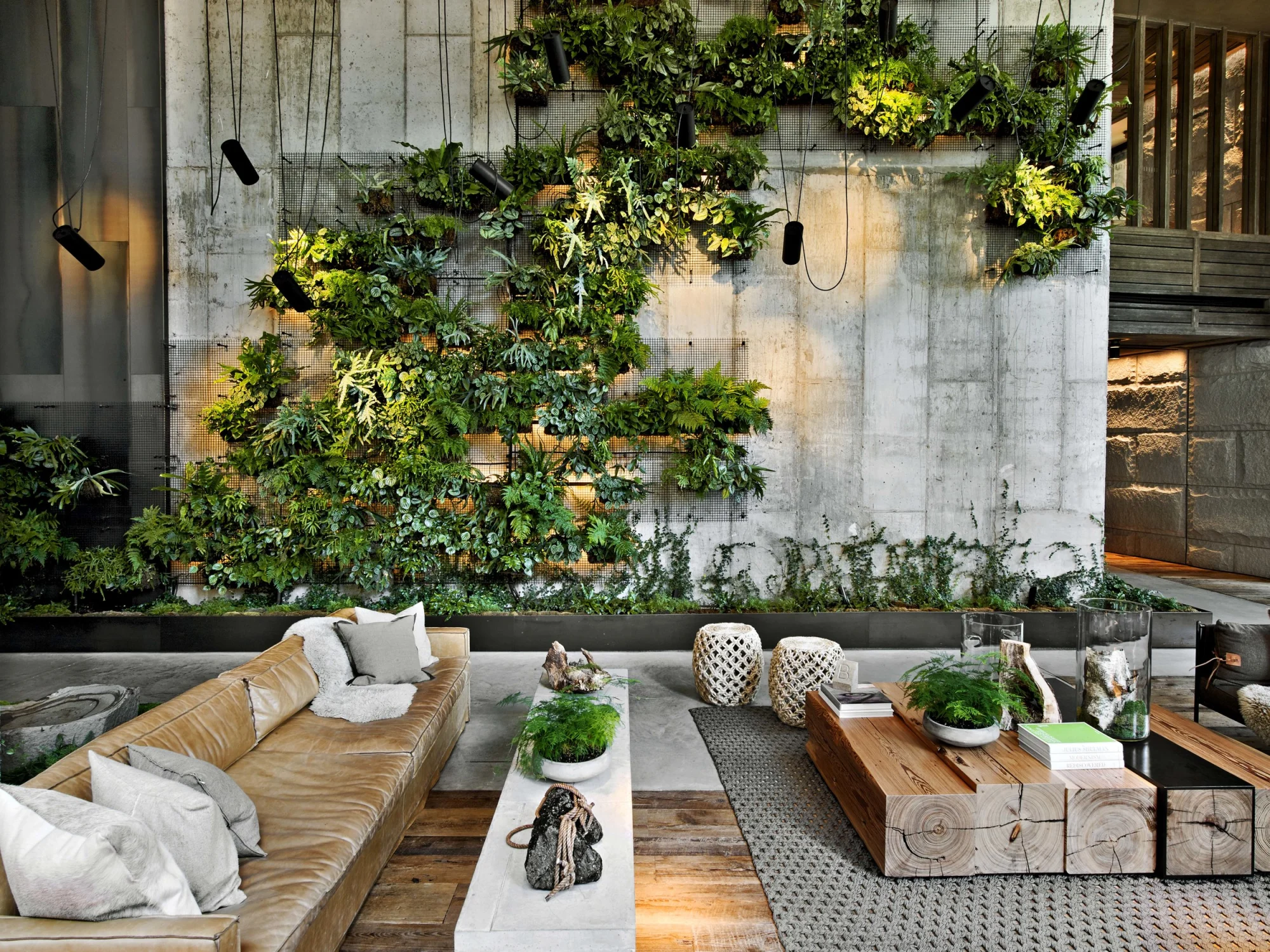 plant wall, lobby, sofa, concrete, biophilic, textural, bench, coffee table, pillows, wood table, wood flooring, lighting