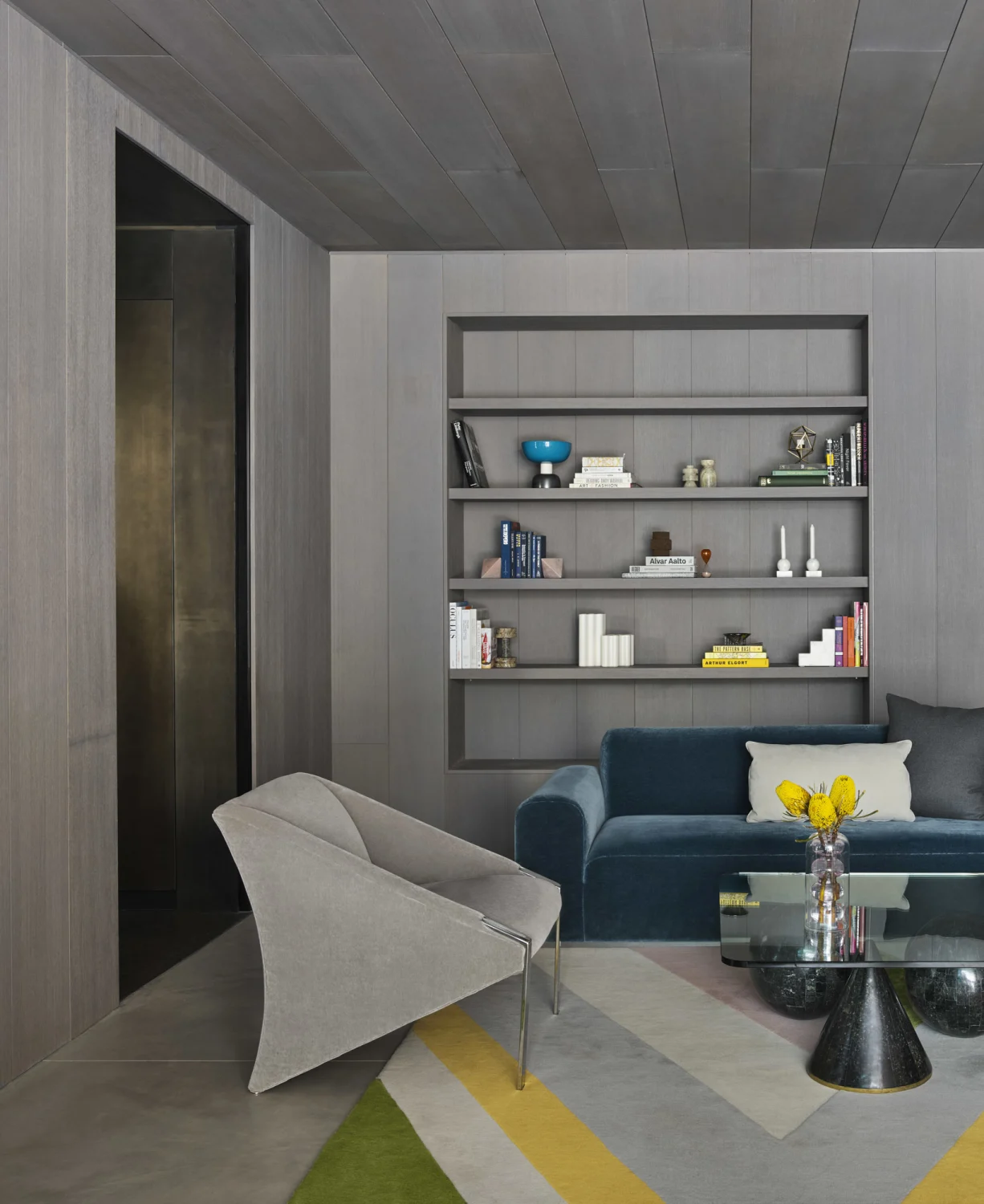 bookshelf, sofa, rug