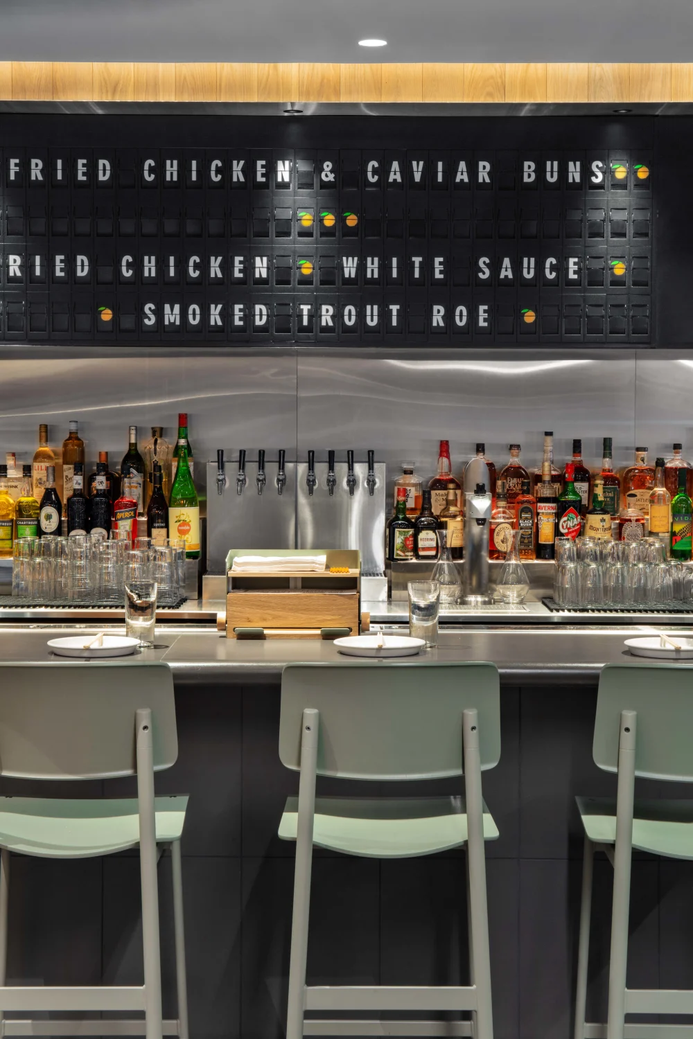 SIGNAGE, bar, steel counter, green stools