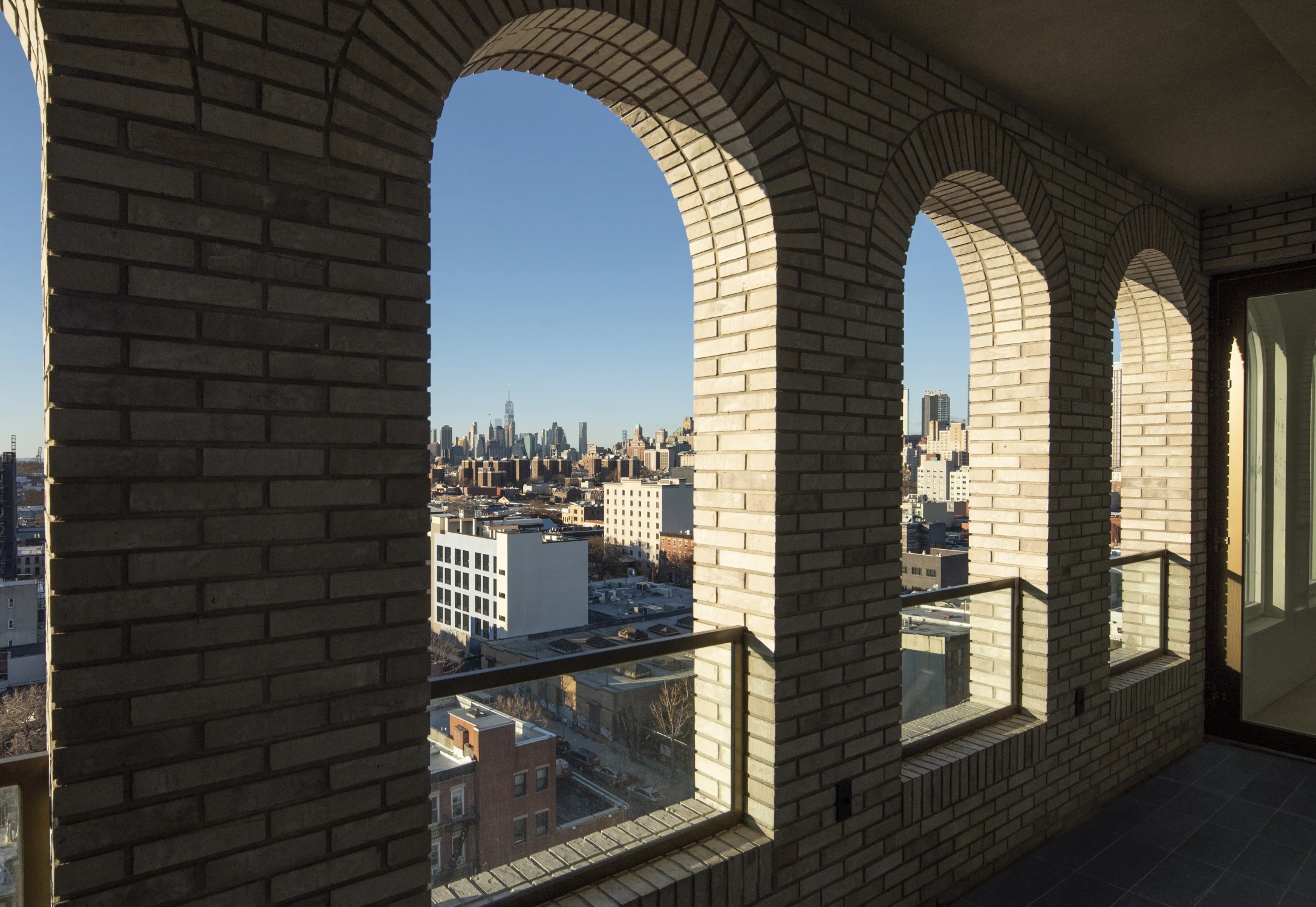balcony, glass railing, arches, skyline view