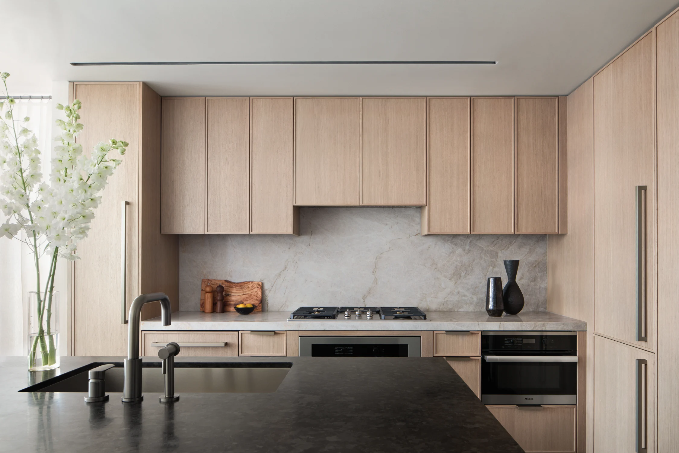 kitchen, wood cabinets, island, sink, stone, black and white, flowers