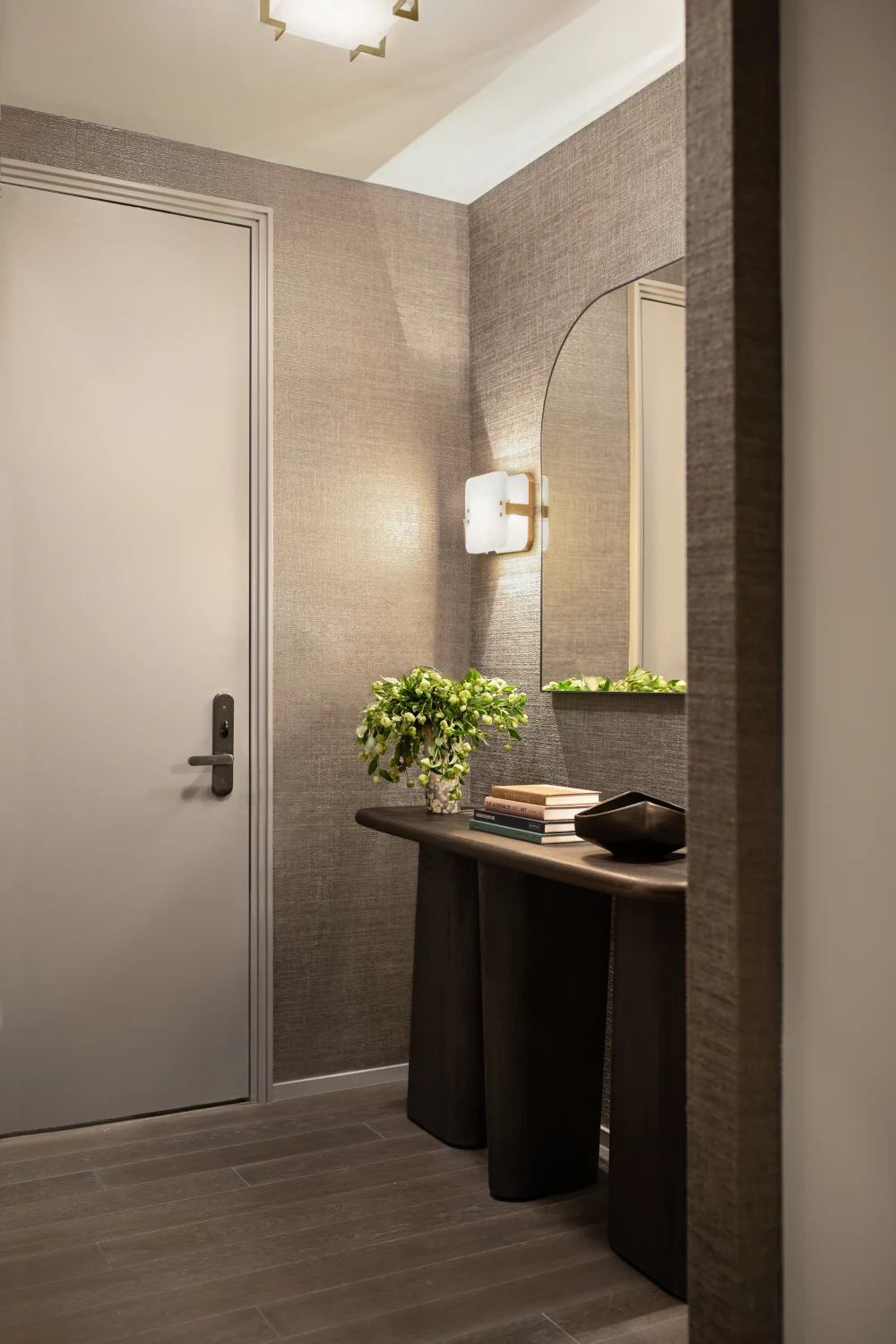 entrances, credenza, mirror, wall mounted lights, plants, wood flooring