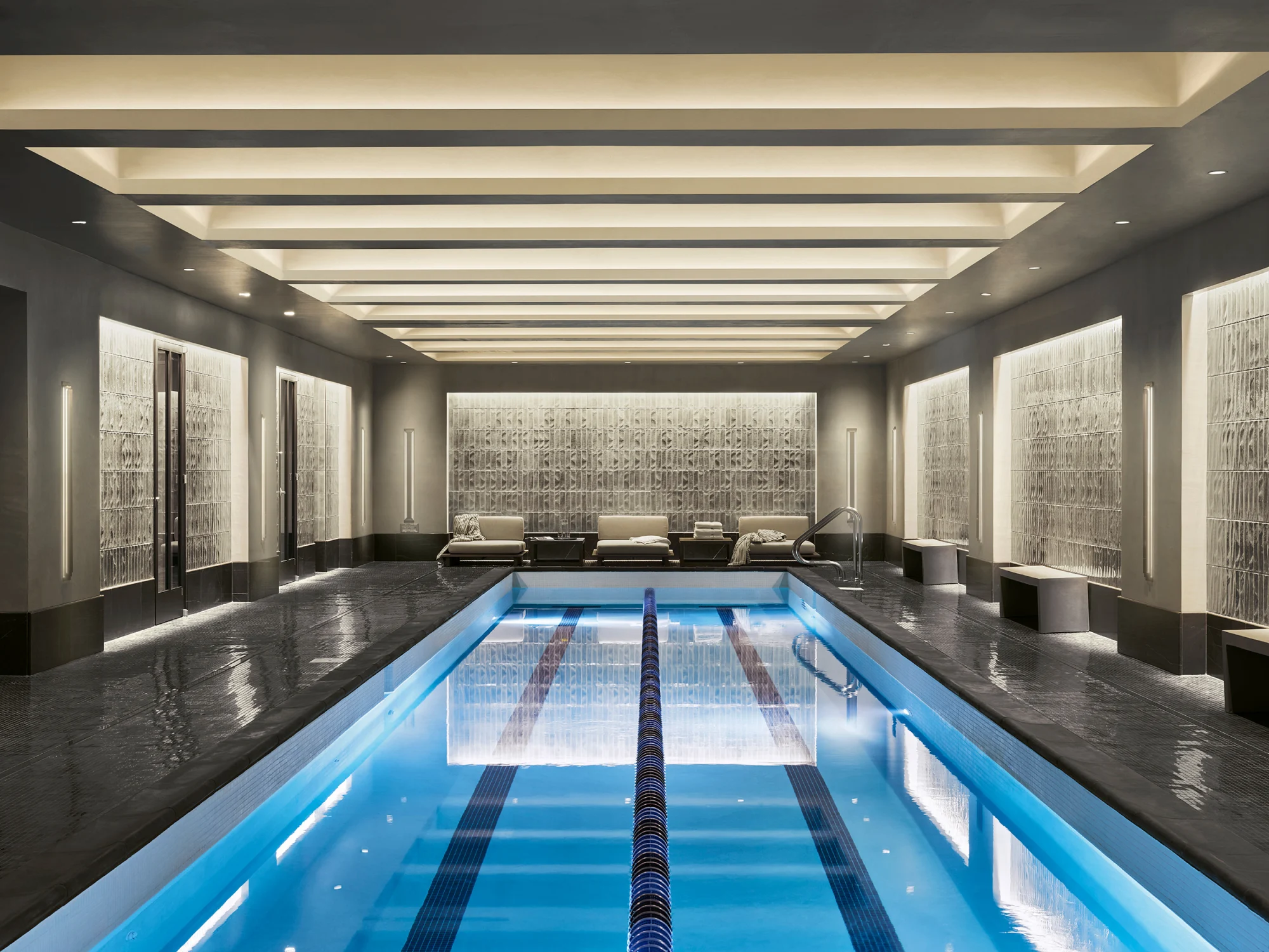 pool, indoor pool, swimming, lighting, textured wall, symmetry, seating