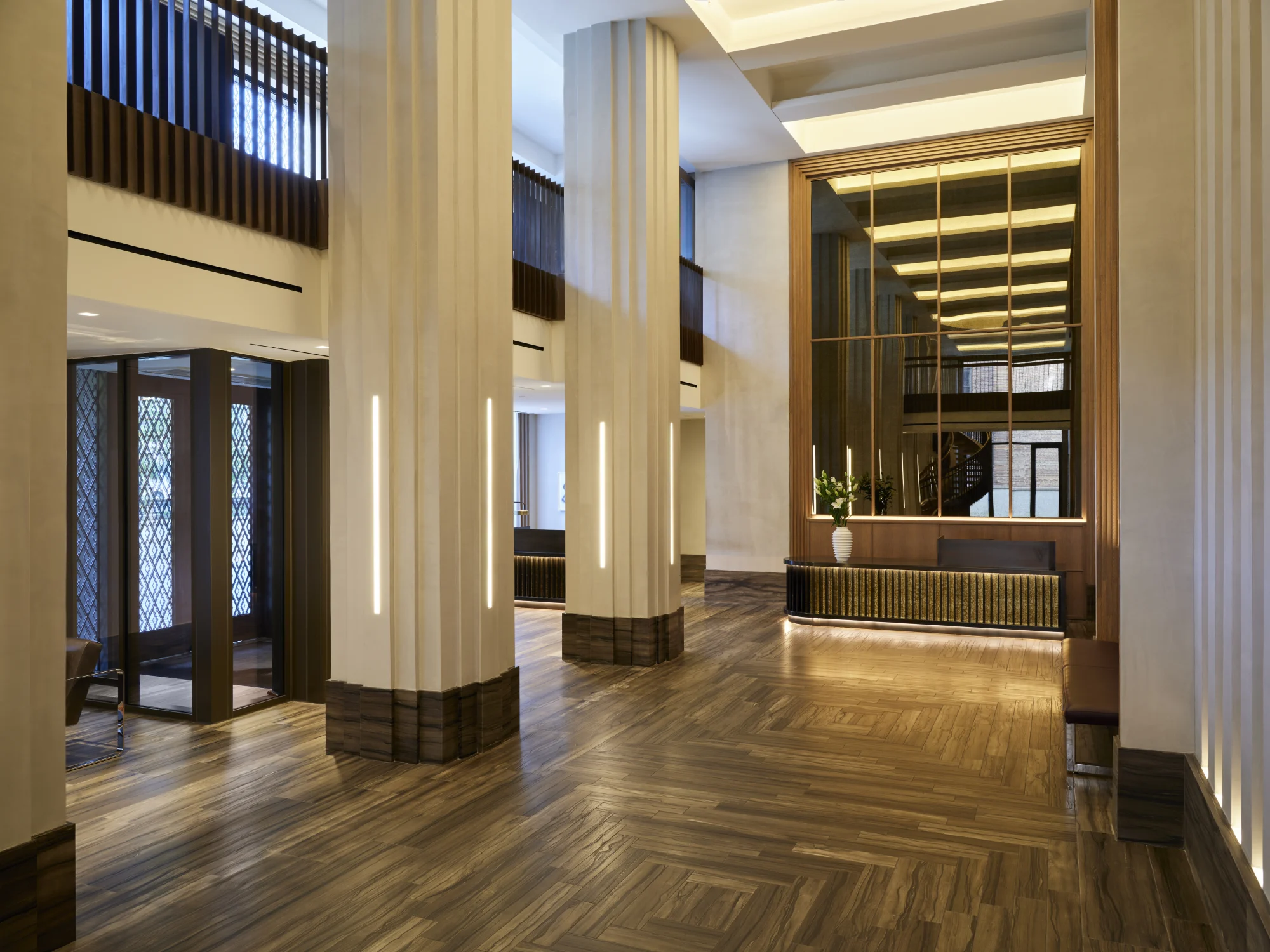 reception, lobby, entrance, columns, baseboards, wood flooring, lighting