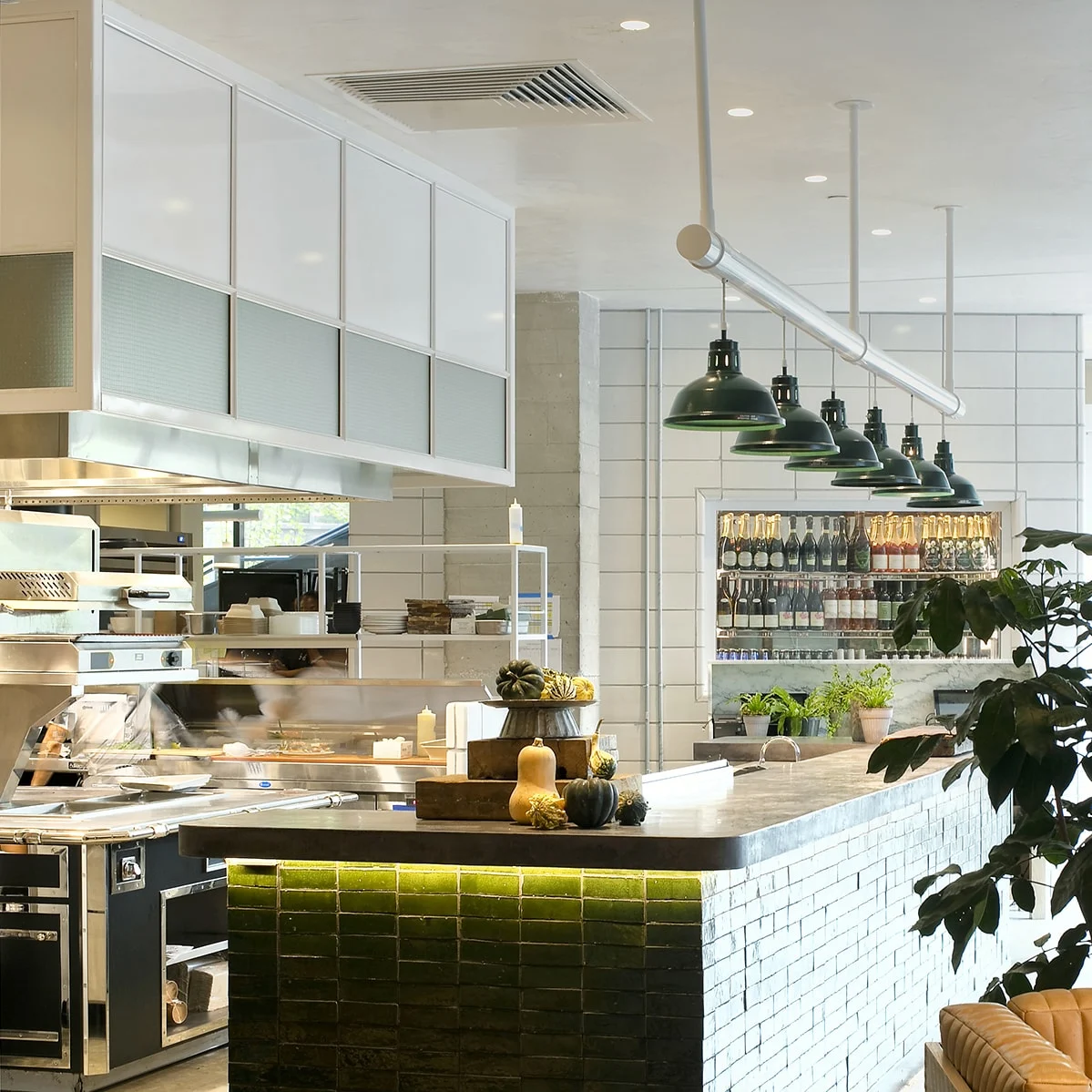 Countertop,  Green tiles,  Pendant lights , Kitchen equipment,  Wine bottles  ,Lamps,  Open shelves,  Menu board,  Cutting boards,  Indoor plant