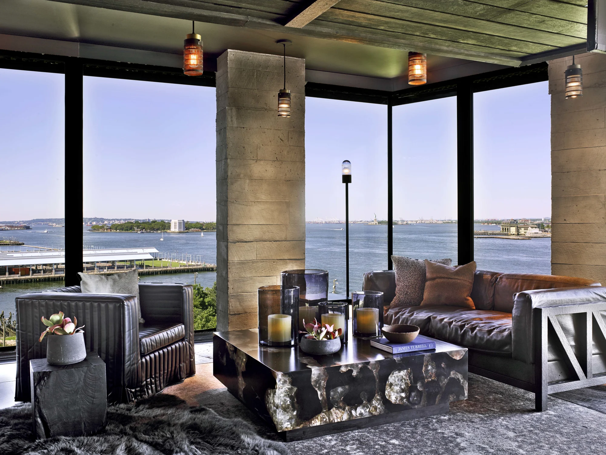 view, coffee table,Leather, couch,Candle,Rug,Industrial lamp,armchair,pillows,concrete