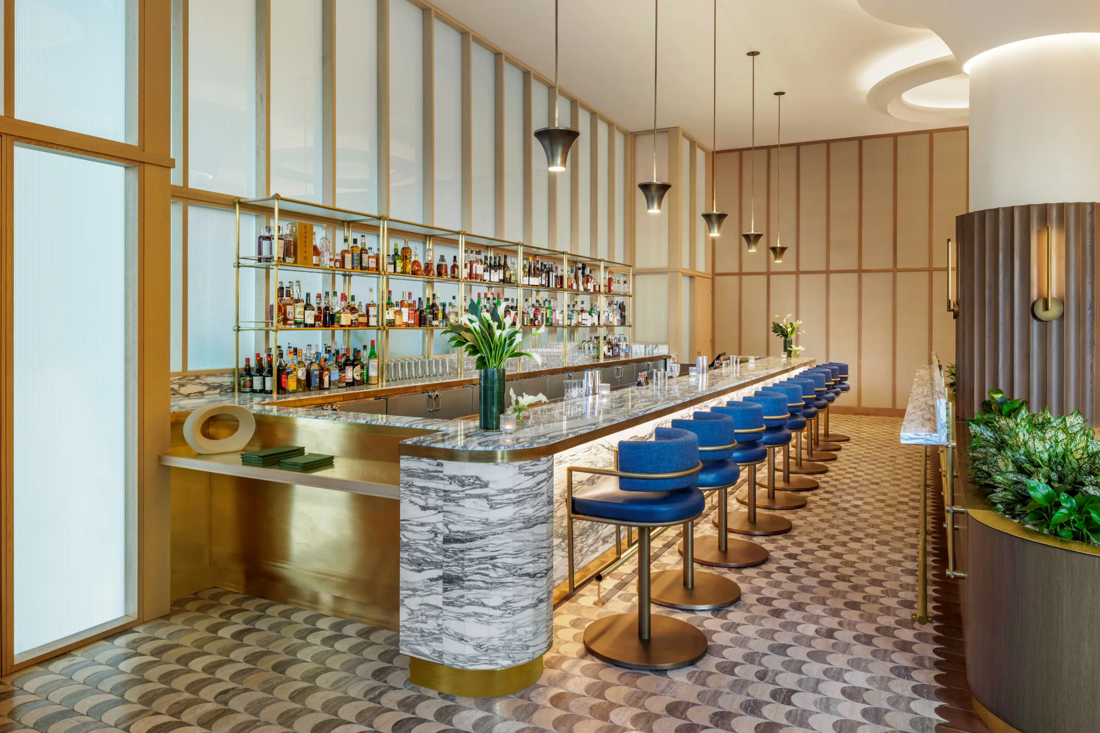 Bar, patterned flooring, bar stools, shelves, pendant lights, blue, glass, shelves, plants