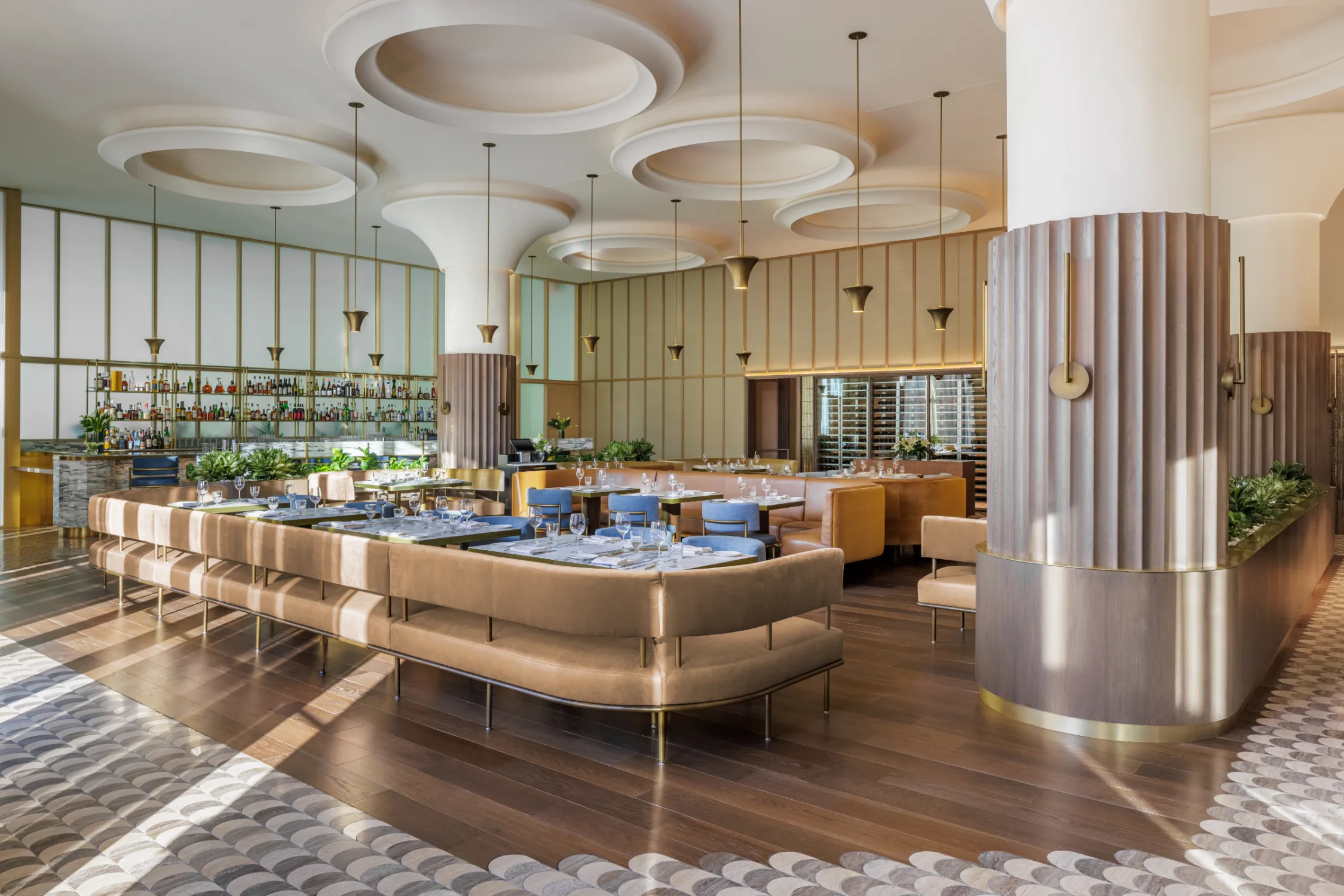 Restaurant, sofa seating, pendant lights, mushroom columns, patterned flooring, wood flooring, blue
