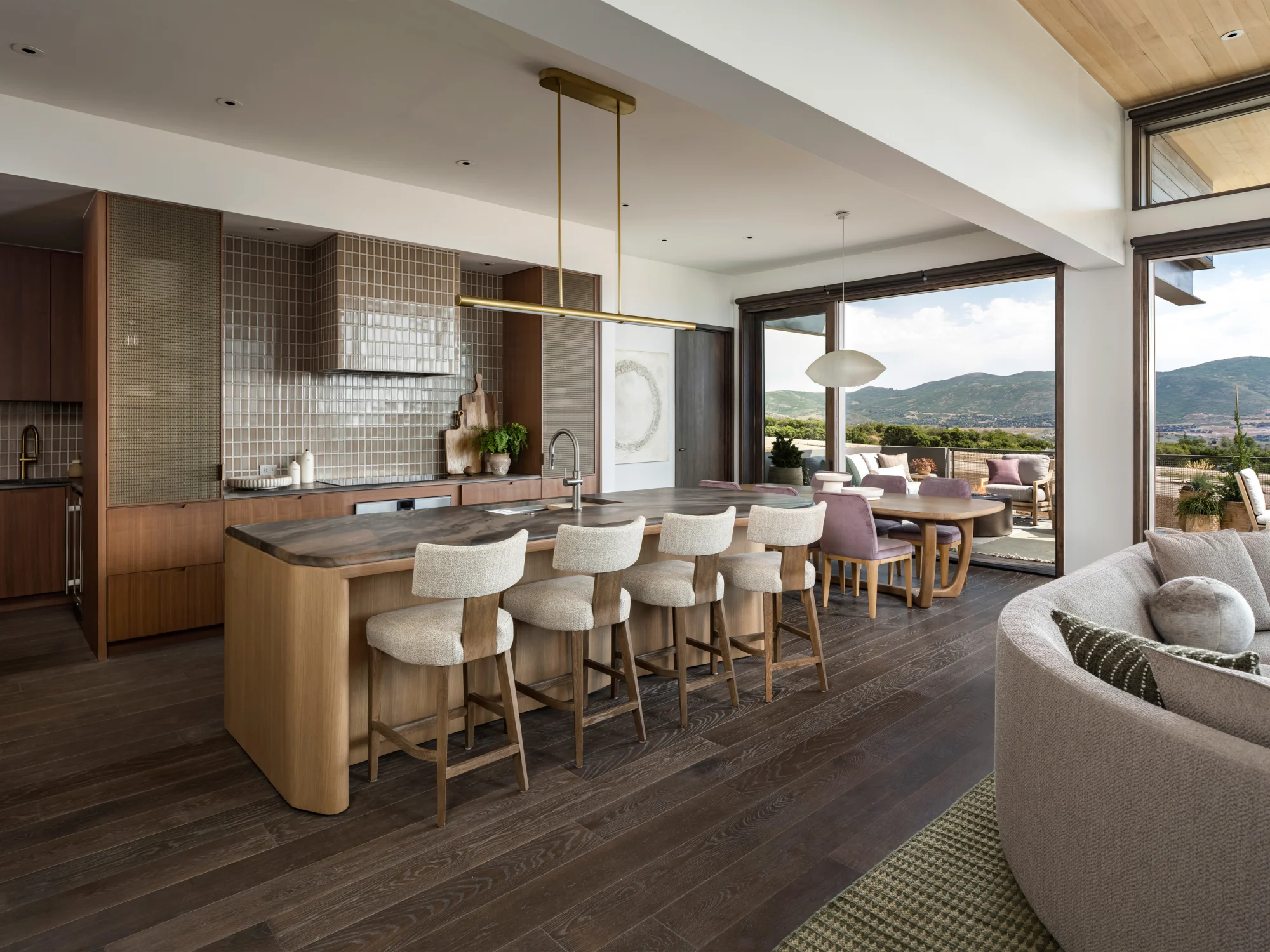 Kitchen, hanging light, wood flooring, sofa, island, island chairs, glazed tiles