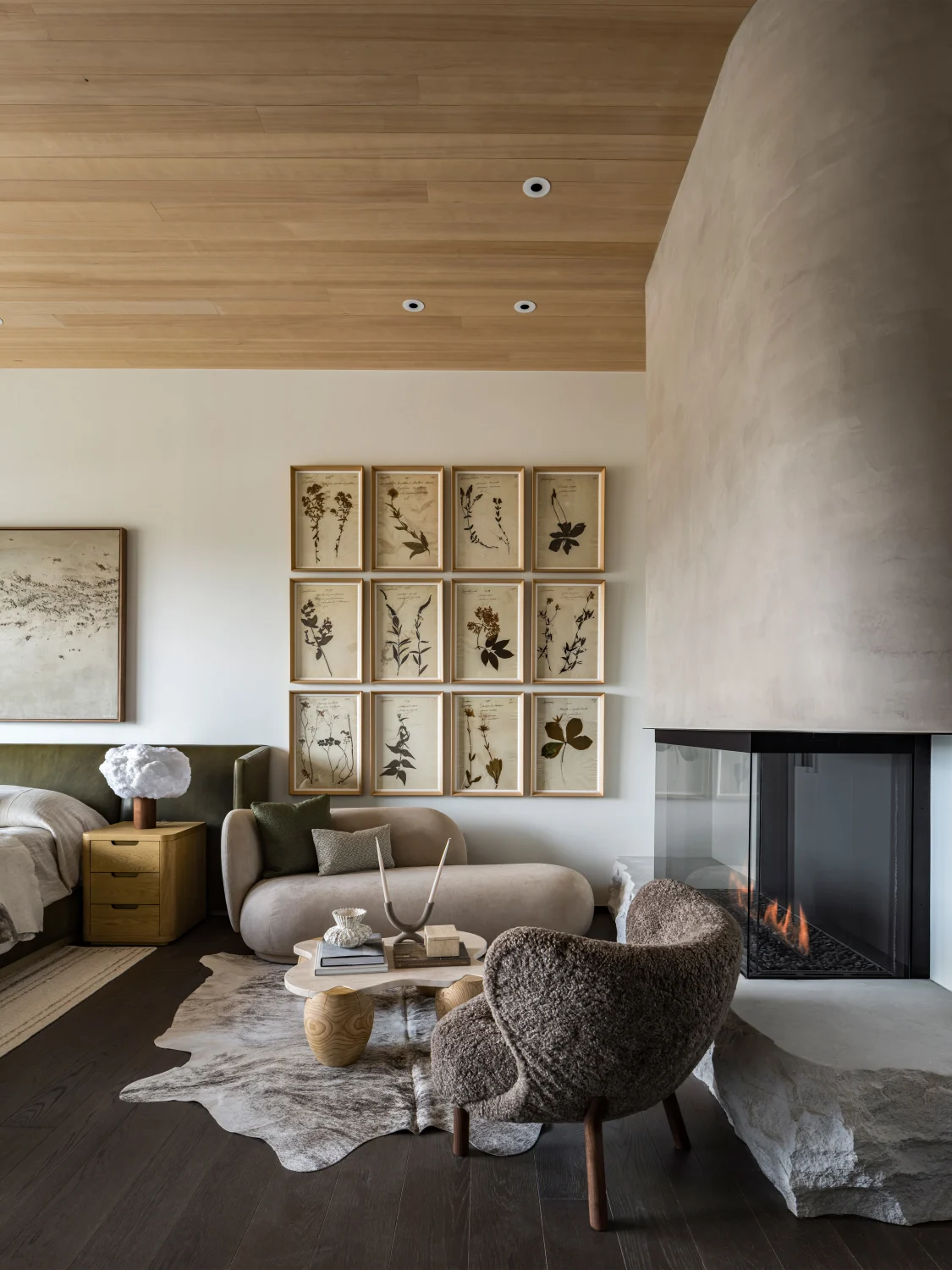 Fireplace, art, chair, rug, wood flooring, stone, sofa seating, center table