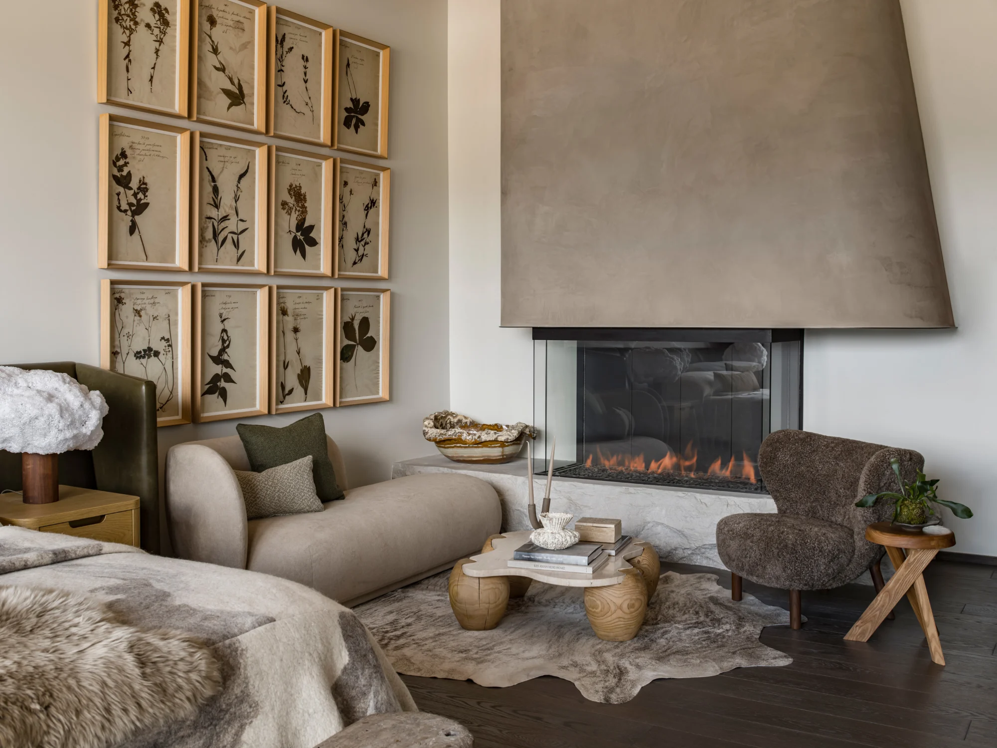 Art, bedroom seating, fireplace, chairs, sofa seating, table, rug, woof flooring, concrete finish