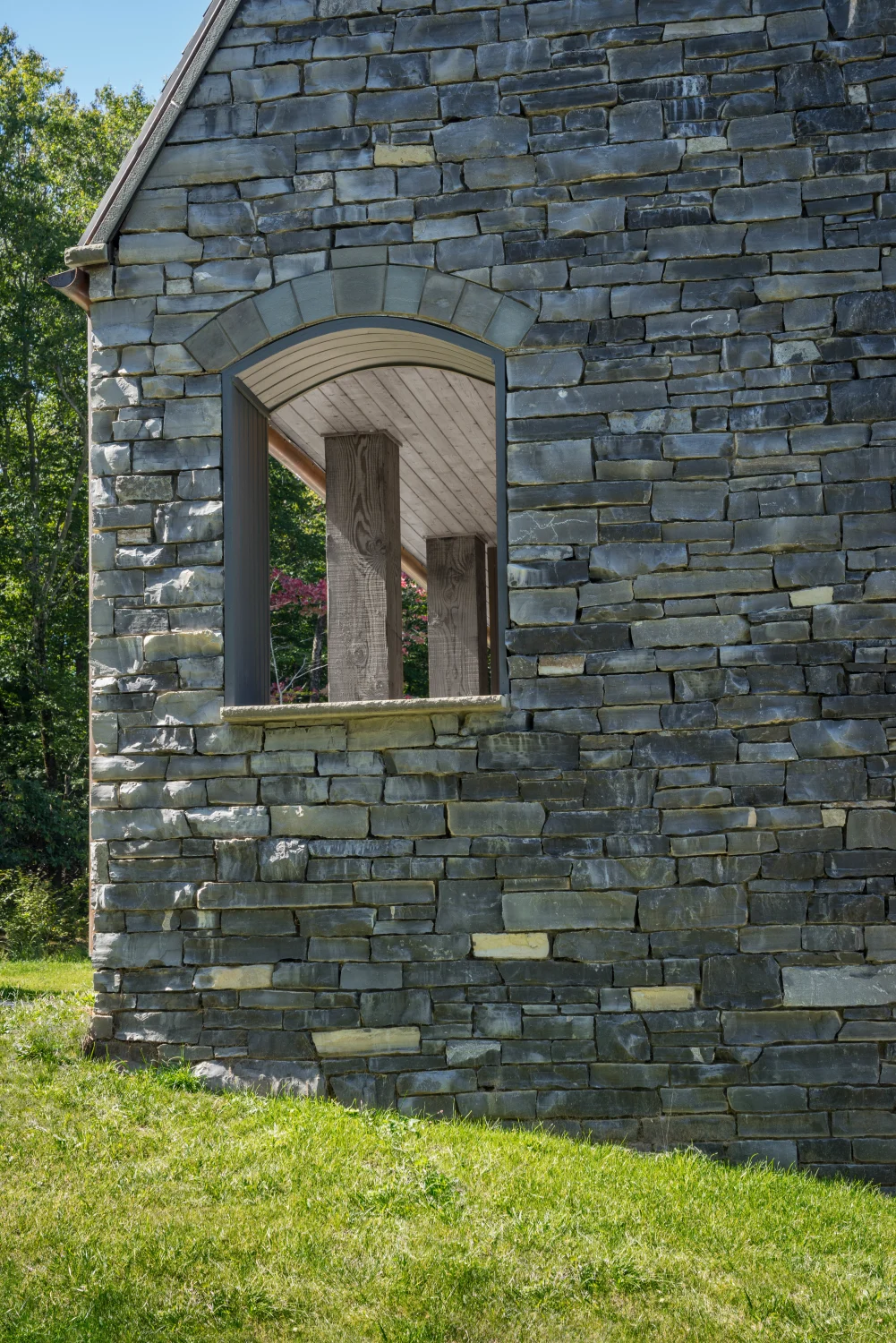Stone wall, exterior, arched window, lawn