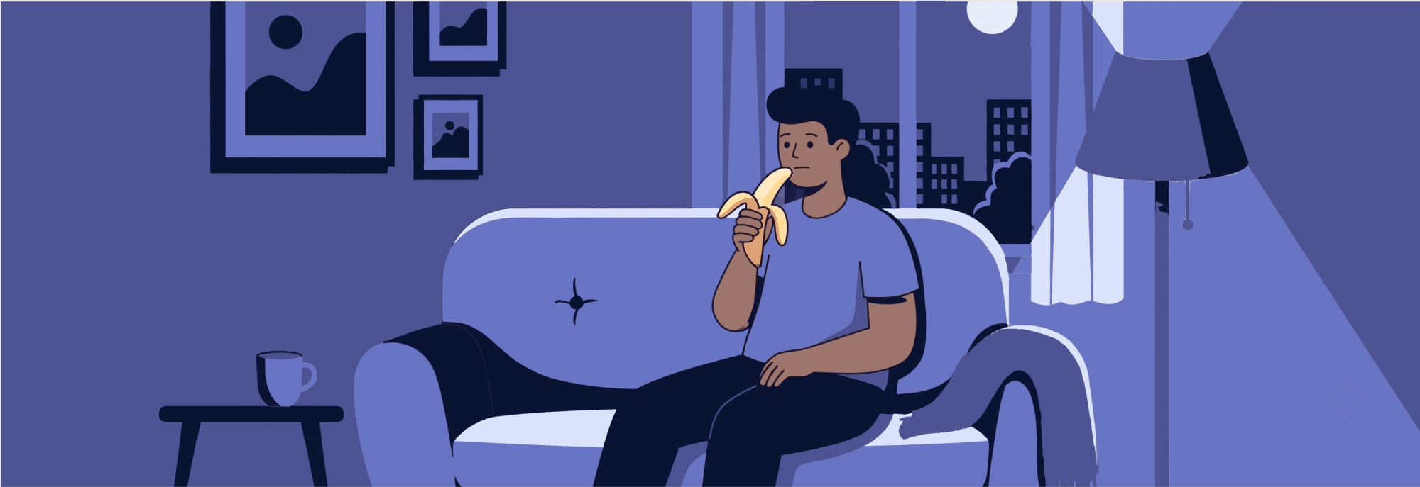 Person on a couch at night, eating a banana, warm low light, casual setting