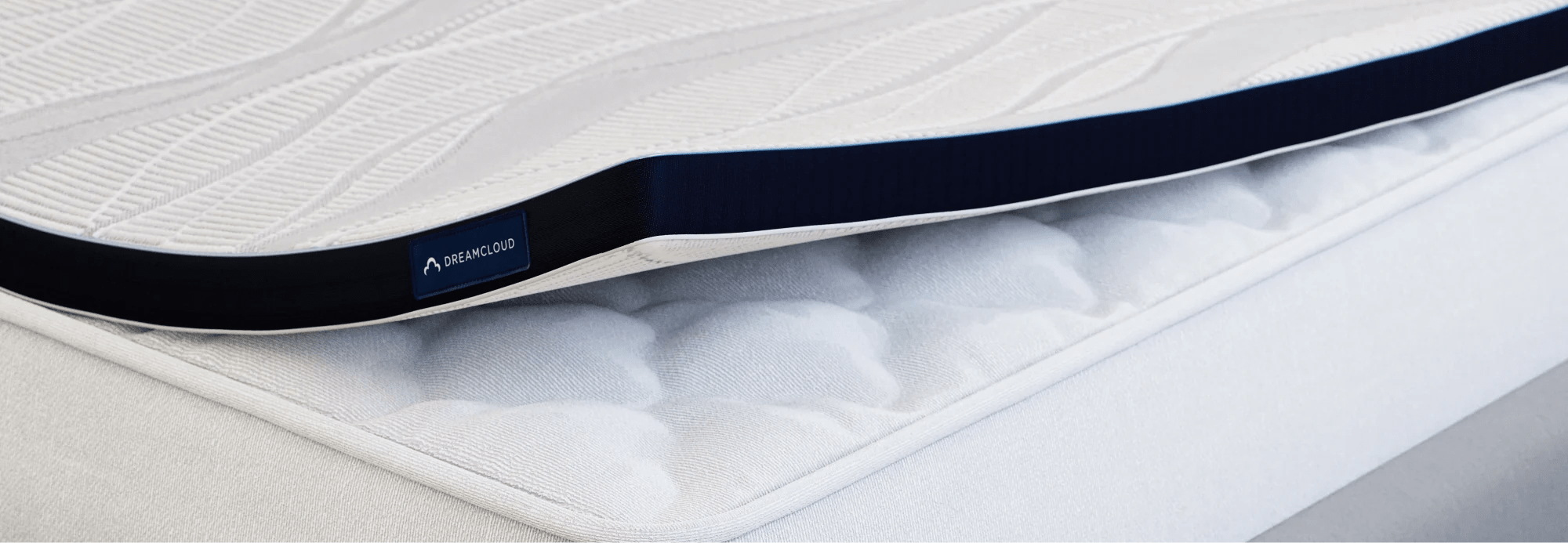 DreamCloud mattress topper on a plain mattress