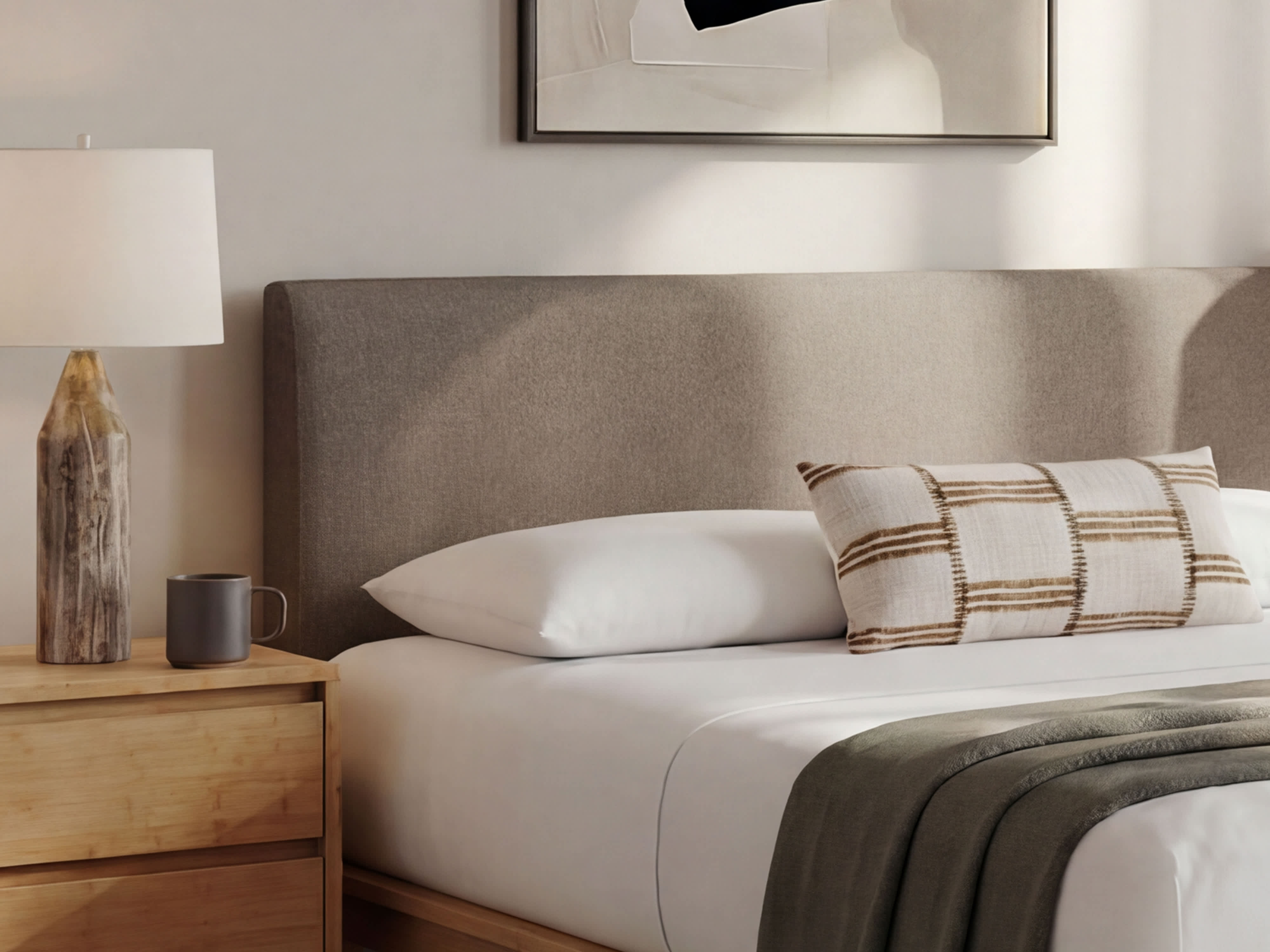 bamboo beframe with grey upholstered headboard in a bedroom