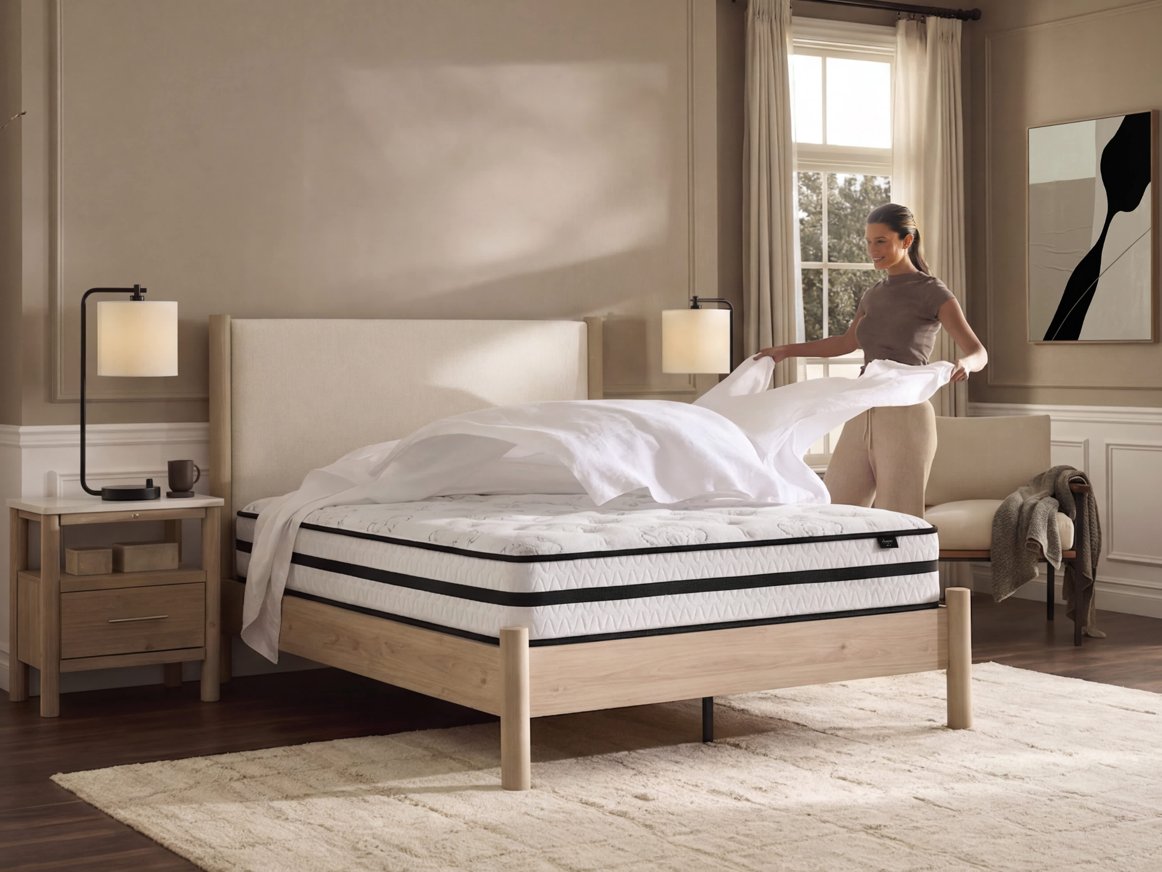woman putting sheets onto a bed