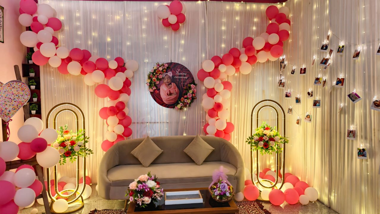 Balloon arch and floral backdrop event decoration