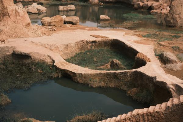 Workers blending clay inside the Kano mud pit