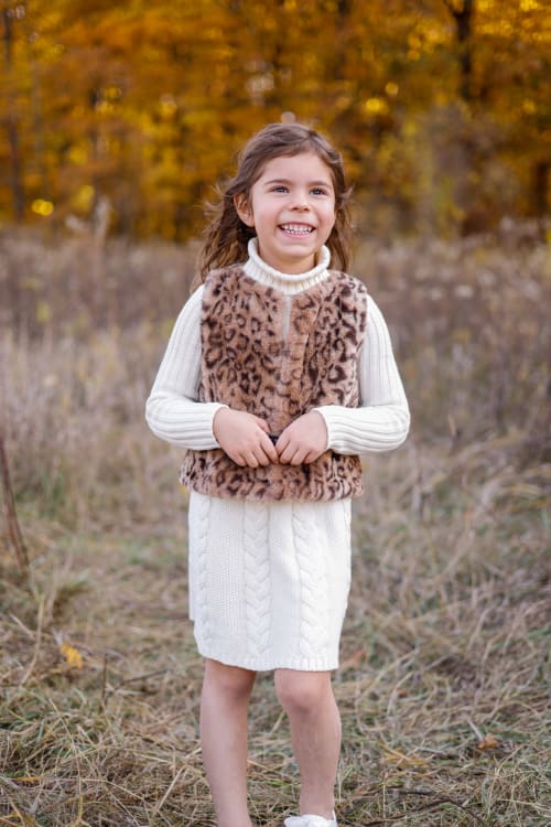 Young girl in a leopard vest and white dress in an autumn field, southeast Michigan family session