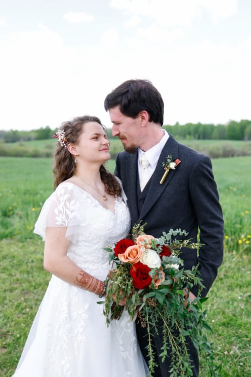 Bride and groom touching foreheads, bride holding an autumn bouquet, Metro Detroit wedding