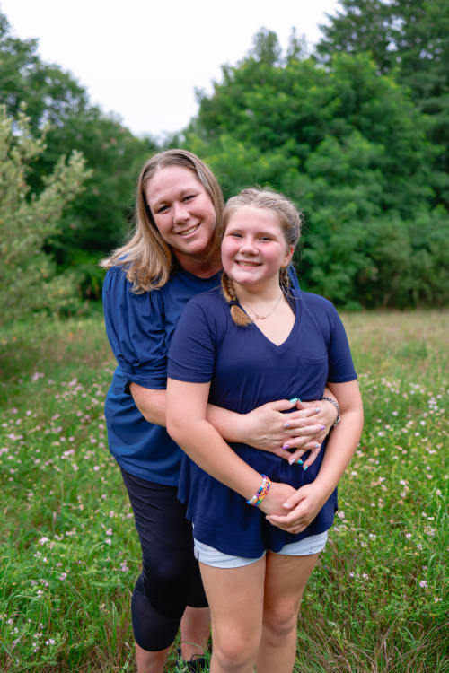 Mother and daughter smiling together in a wildflower field, southeast Michigan family session