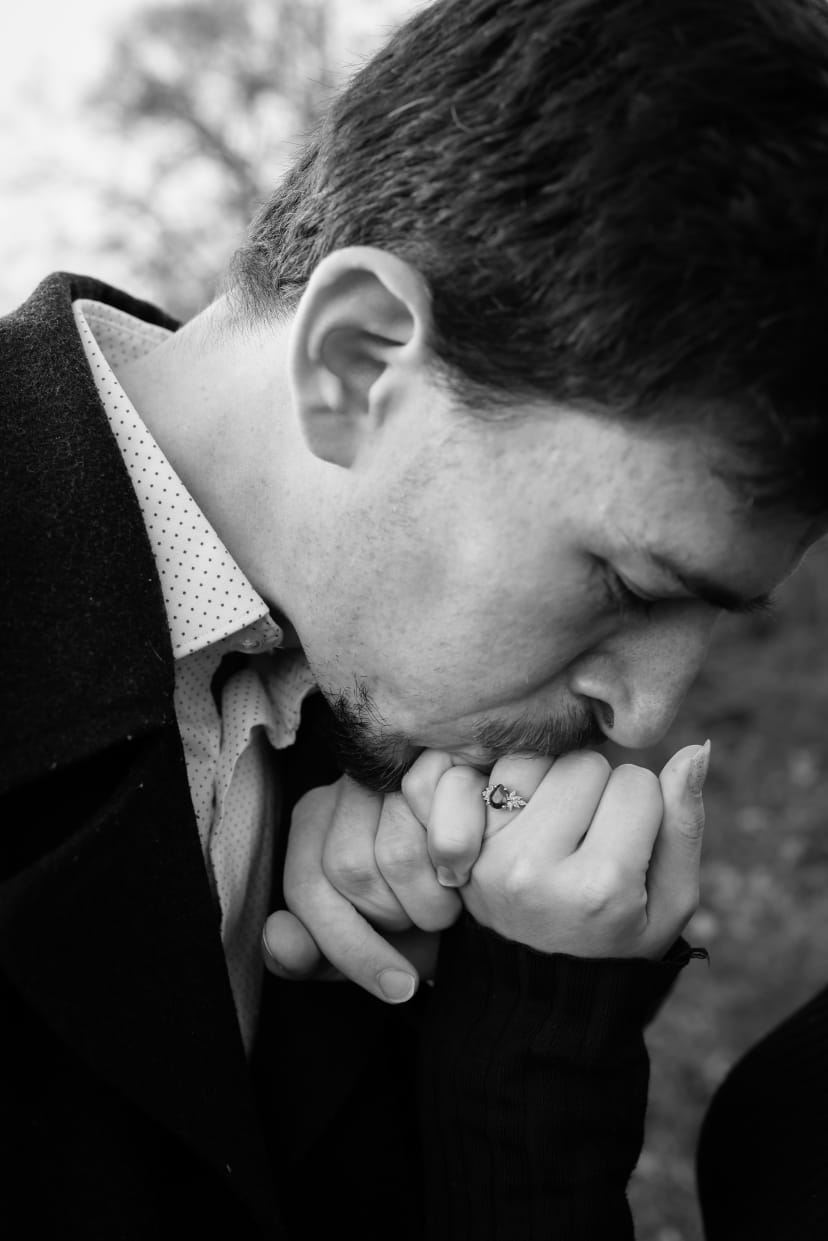 Black-and-white close-up of a man kissing his fiancee's ring hand, Metro Detroit engagement