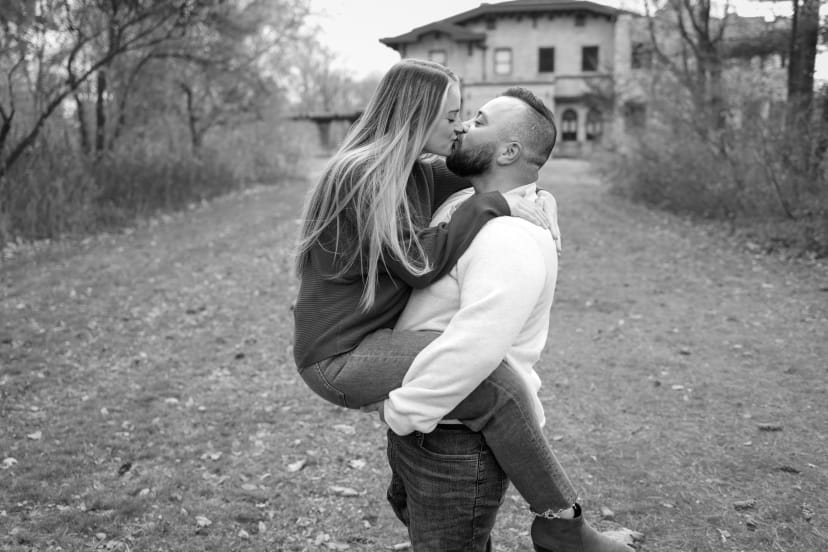 Black-and-white portrait of a couple kissing outdoors, southeast Michigan couples session