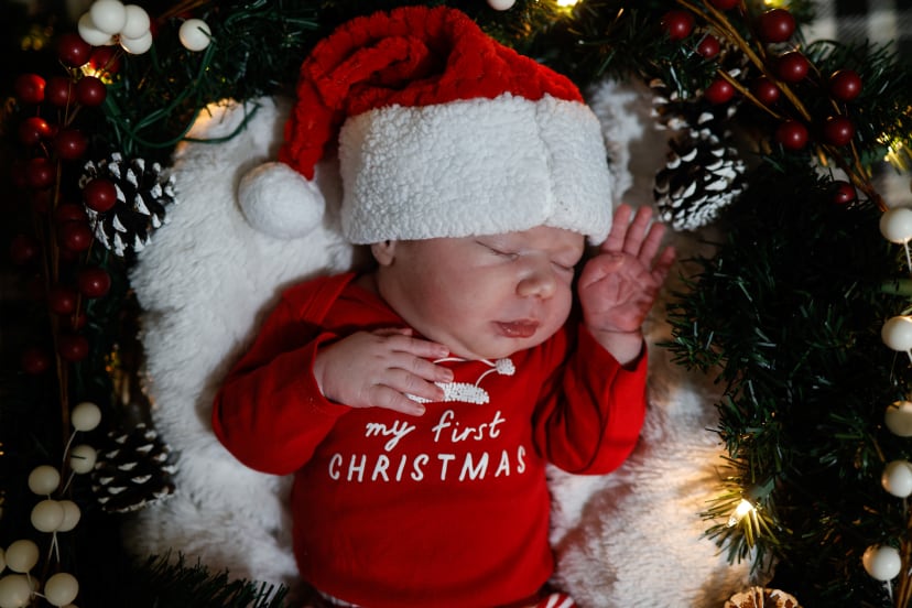 Newborn in a 'my first Christmas' outfit and Santa hat, Metro Detroit Christmas newborn session