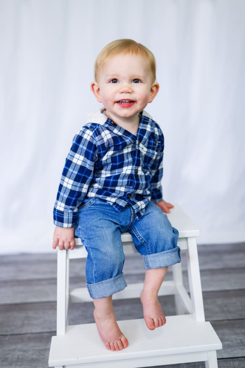 Toddler boy in a plaid shirt sitting on a stool, Metro Detroit studio portrait