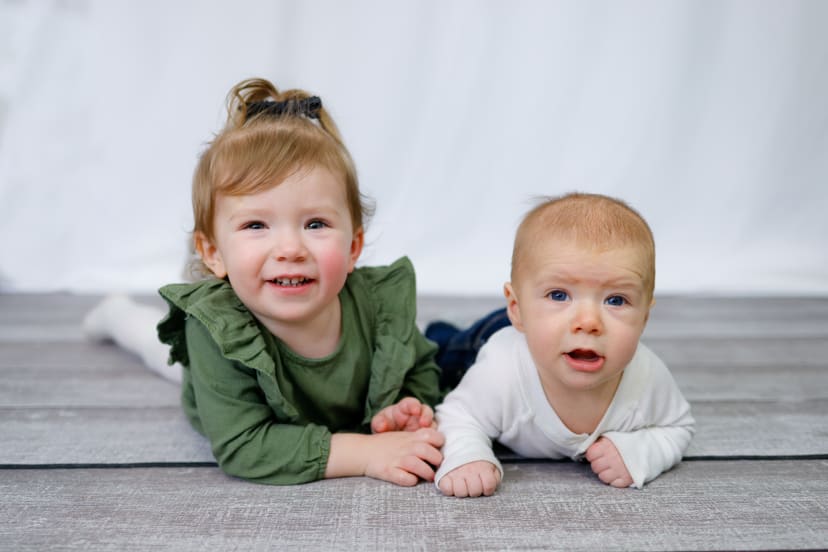 Toddler and baby lying side by side, Metro Detroit siblings session