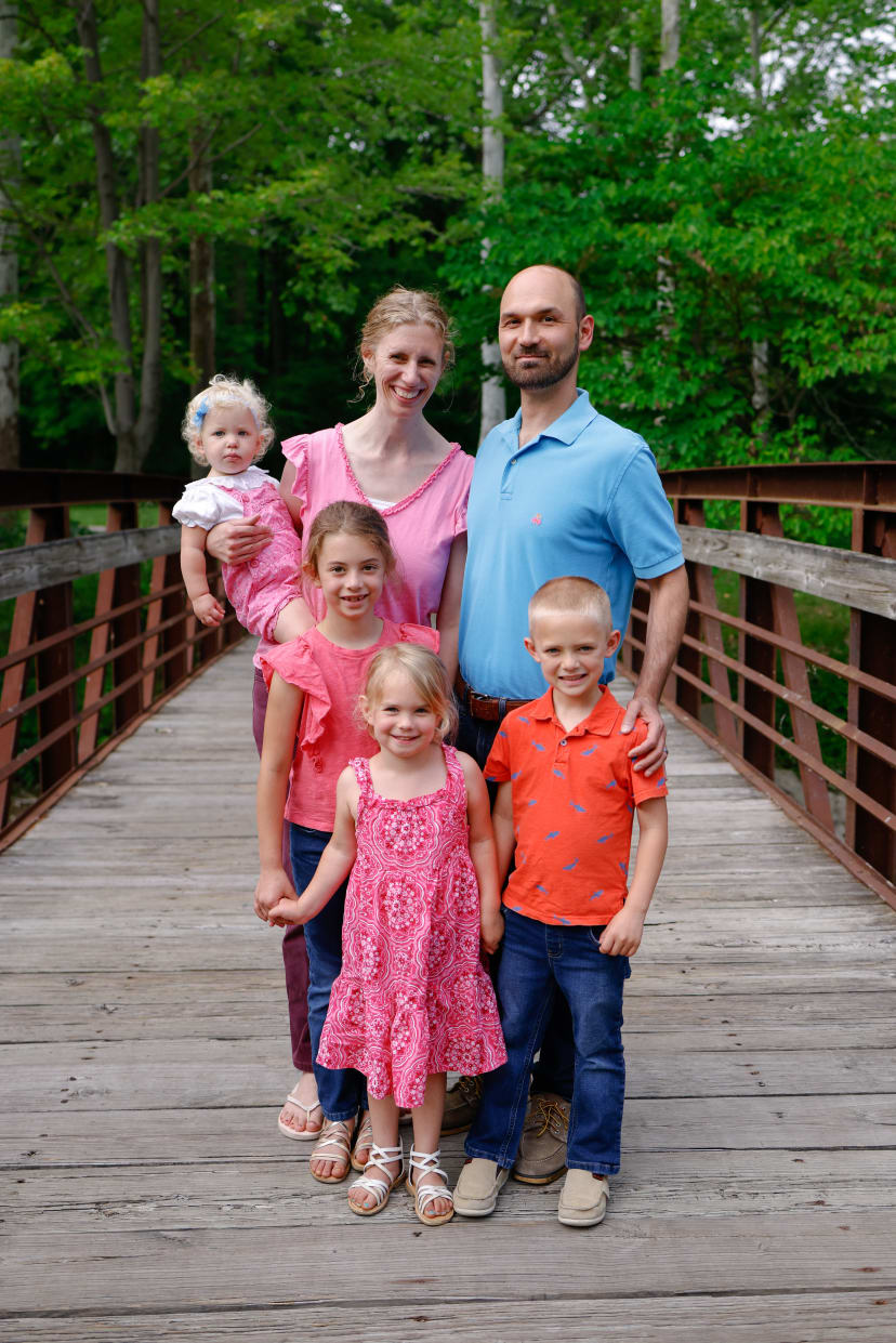 Family of six posing on a wooden bridge, southeast Michigan family session