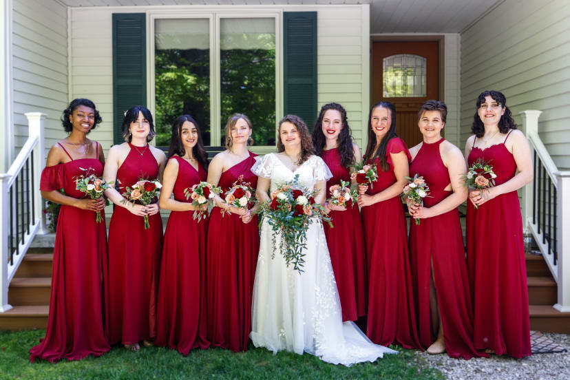 Bride with her bridesmaids in red gowns holding bouquets, Metro Detroit wedding