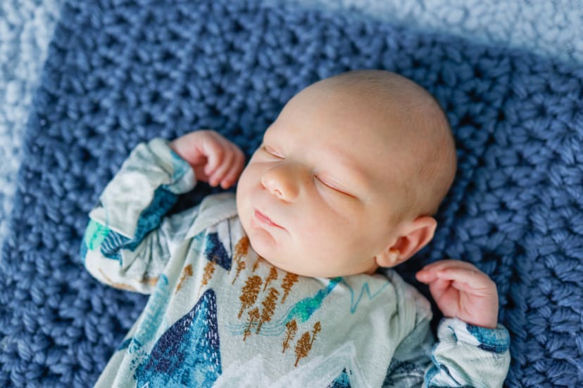 Close-up of a sleeping newborn on a blue knit blanket, Metro Detroit newborn session