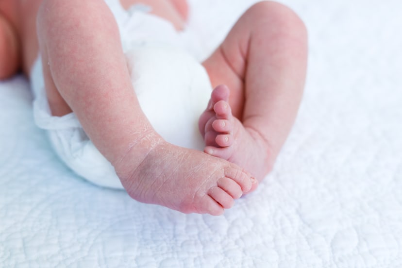 Close-up of a newborn's tiny feet cradled in a hand, Metro Detroit newborn details