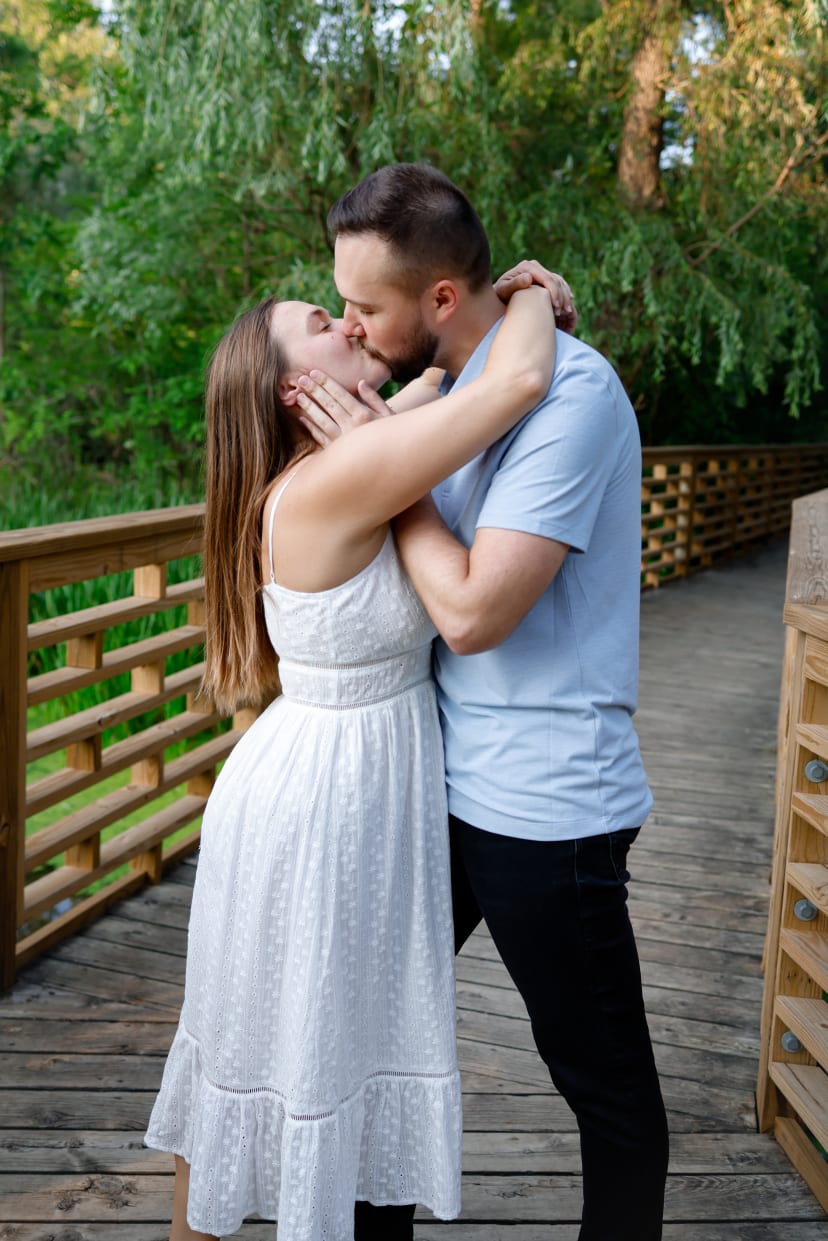 Couple kissing on a wooden bridge, southeast Michigan engagement