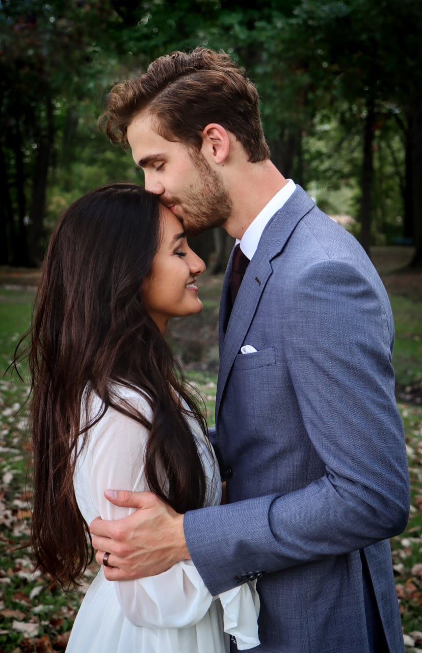 Couple touching foreheads, groom in a blue suit, Metro Detroit wedding