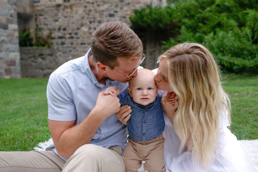 Parents kissing their baby boy from both sides, southeast Michigan family session