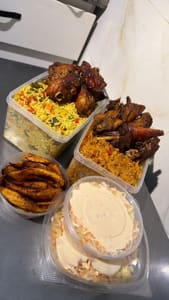 A bowl of Jollof rice, plantain and salad with Chicken