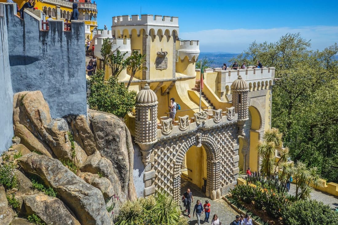 The colourful domes and ornate gateway of Pena Palace above Sintra, an easy day trip from Lisbon