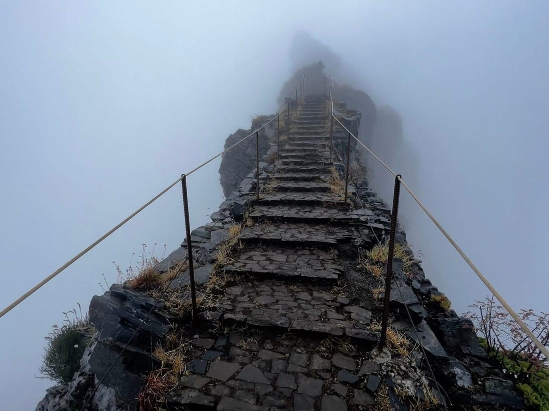 Stone staircase of the PR1 trail cut into the ridge between Pico do Arieiro and Pico Ruivo