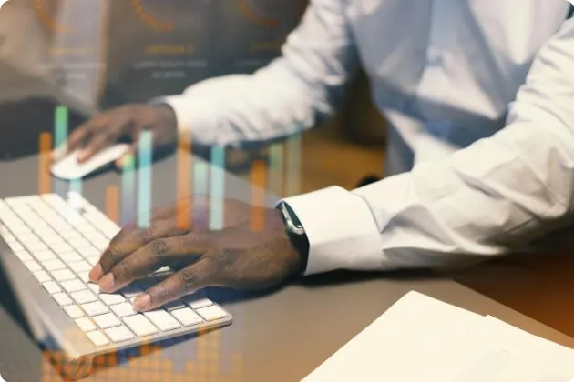 Image of a tester in front of a laptop testing a software system