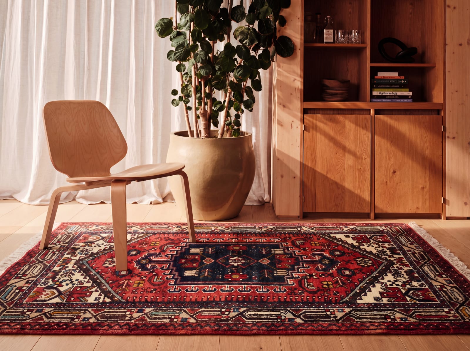 Tribal rug shown in a furnished interior