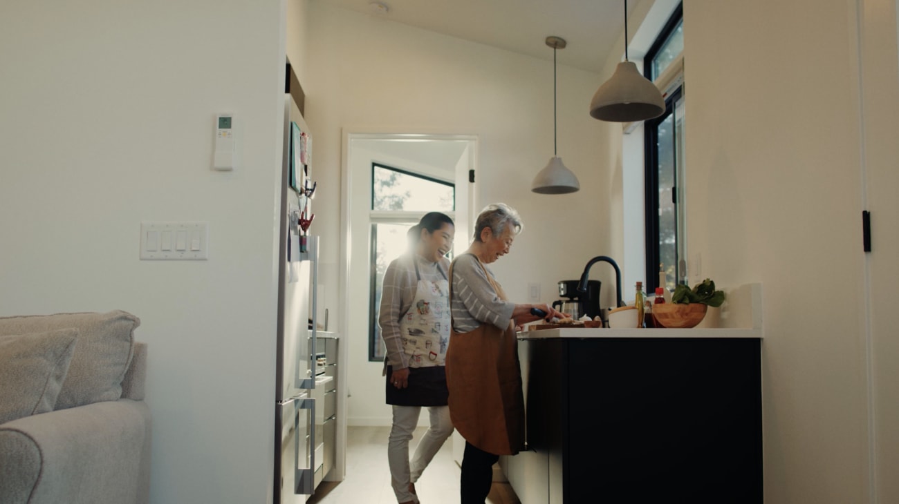 A daughter and mother enjoying the process of preparing a meal together in the Abodu galley kitchen.