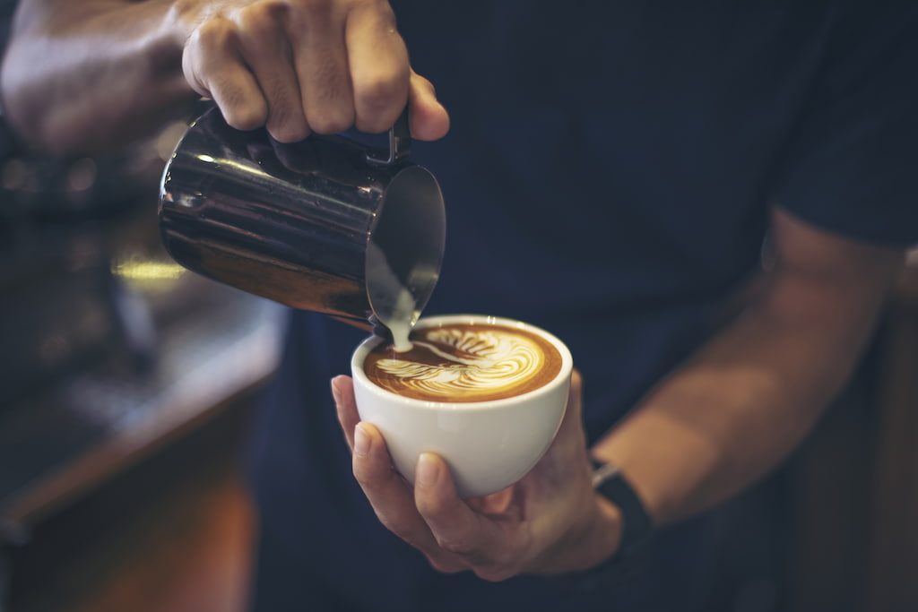 barista pouring milk