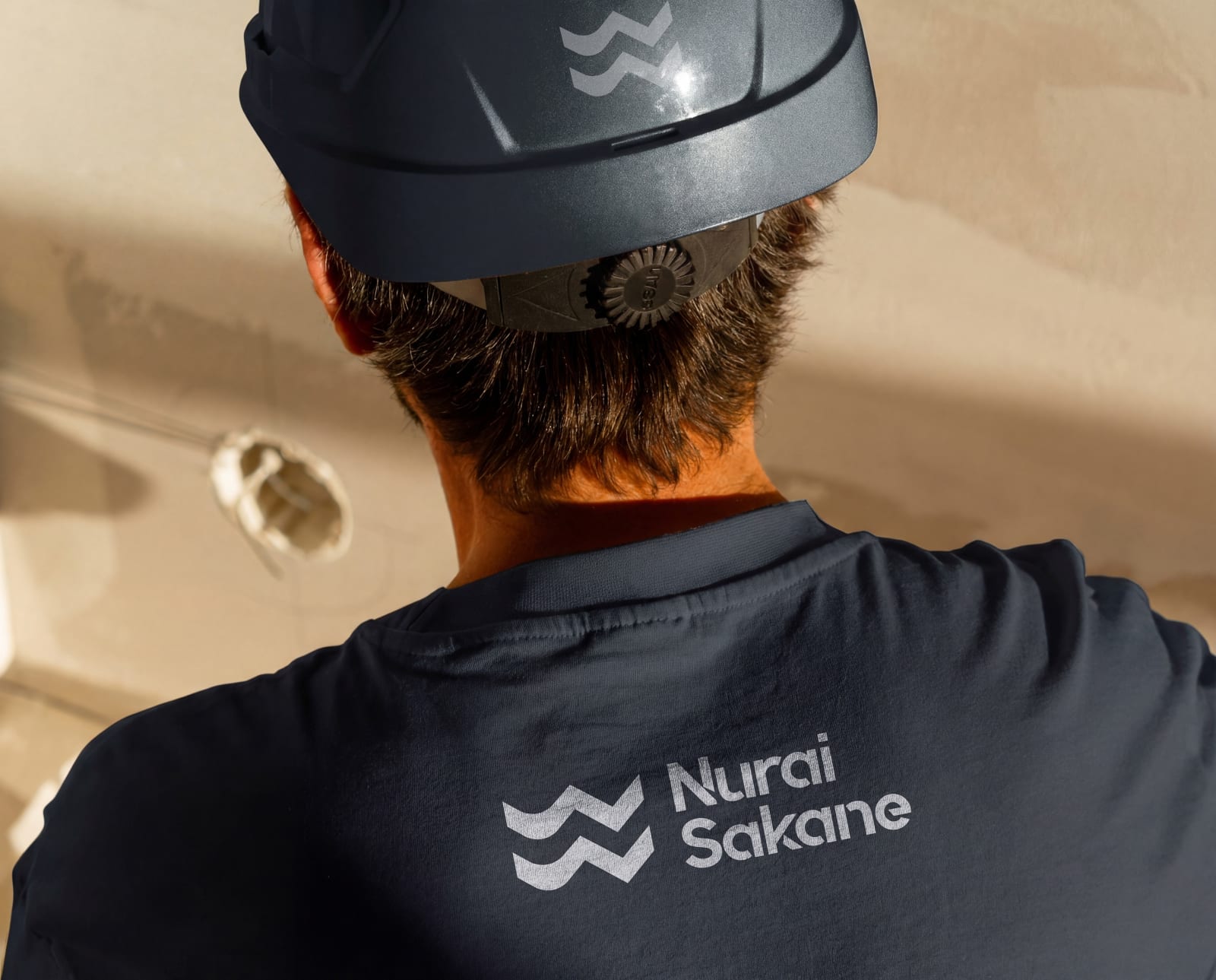 Nurai Sakane brand identity applied to site workwear — consistent real estate branding by Shapedge Studio
