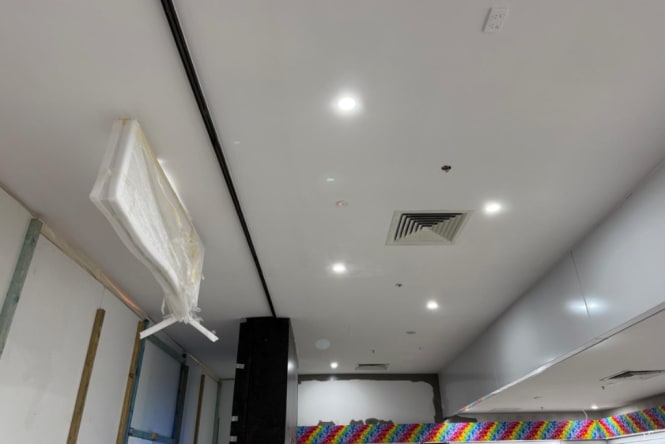 Freshly painted commercial ceiling in clean white finish with recessed lighting throughout. Commercial painting completed by Blue Collar Painting, Gold Coast.