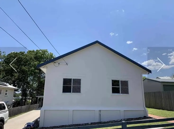 Apartment building exterior with clean white painted finish after professional strata repaint